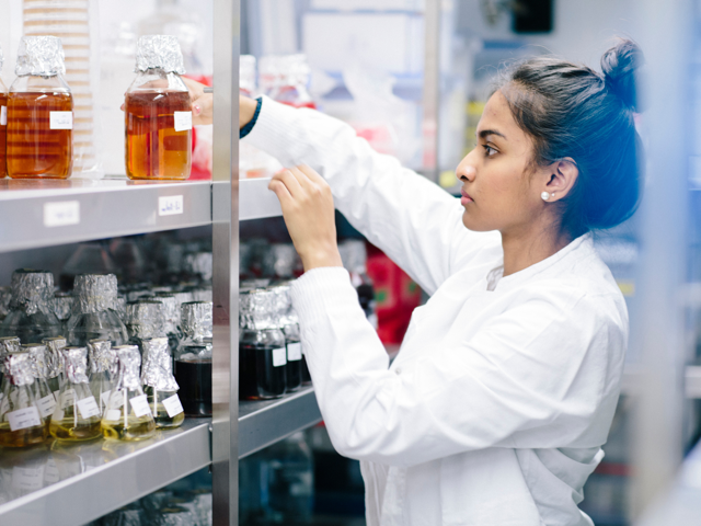 Young woman standing in a cold storage room from laboratory.