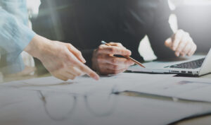 Calibration services documentation review with printed reports and laptop