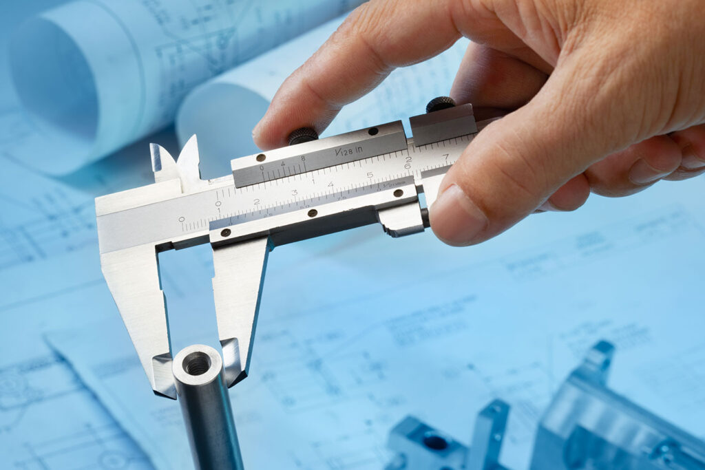Dimensional calibration services caliper measuring a metal rod