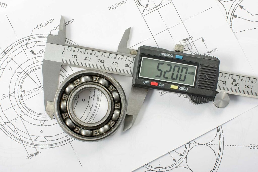 Dimensional calibration services digital caliper measuring a ball bearing