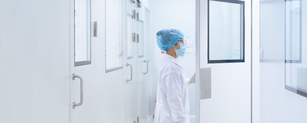 How to certify an ISO cleanroom: worker entering controlled area door