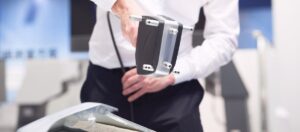 Gravimetric testing technician handling a portable calibration device in a lab setting